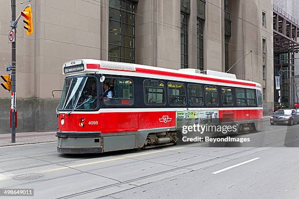 toronto tram stopped at city traffic lights - ttc train stock pictures, royalty-free photos & images