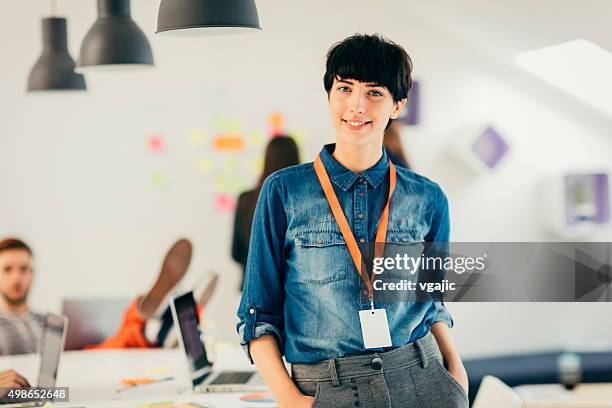 young programmers in her start-up office. - nametag stockfoto's en -beelden