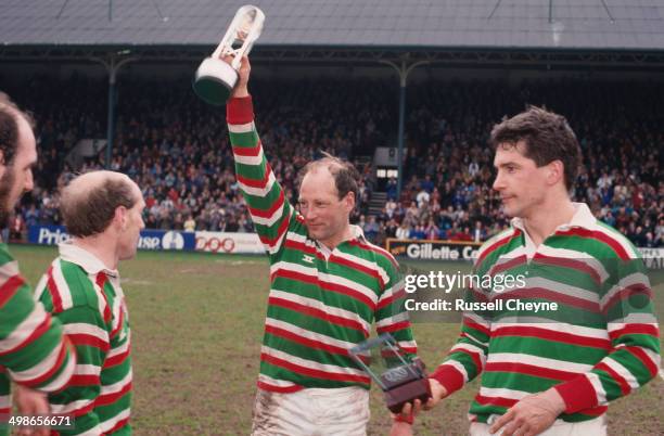 English rugby player Dusty Hare of Leicester Tigers, lifts the trophy after his team's 39-15 win against Waterloo R.F.C. Won them the Courage League...