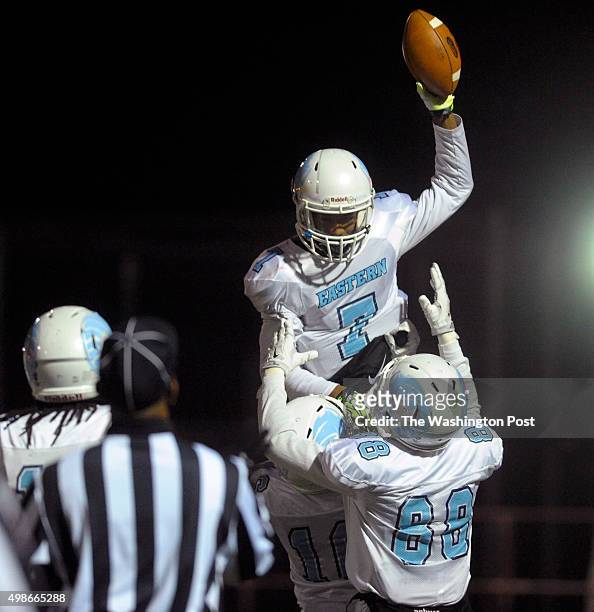 Eastern Ramblers wide receiver Taequon Burton hoists Eastern Ramblers quarterback Jarome Johnson after Johnson scored in the first half of the third...