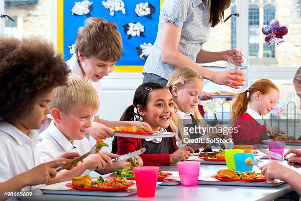 children eating school dinners - caffetteria stock pictures, royalty-free photos & images