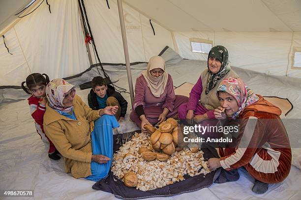 Turkmen women prepare foods for their families who escaped to the Yamadi camp, as Russia and Assad regime forces continue their air attacks on...
