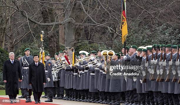 German President Joachim Gauck and Vietnam's President Truong Tan Sang review the honor guards during the welcoming ceremony for an official visit at...