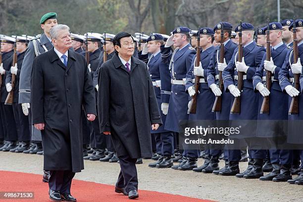 German President Joachim Gauck and Vietnam's President Truong Tan Sang review the honor guards during the welcoming ceremony for an official visit at...