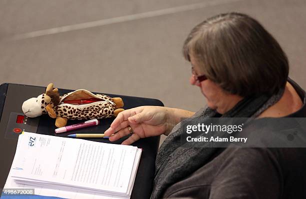 Member of the German Left Party looks through documents next to her toy giraffe pencil case during a meeting of the Bundestag, the German federal...