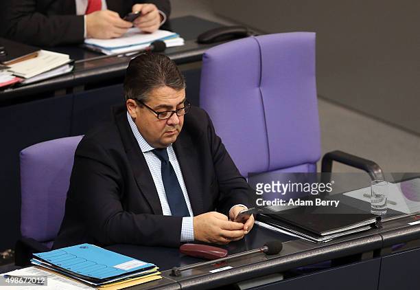 Vice Chancellor and Economy and Energy Minister Sigmar Gabriel uses his mobile phone during a meeting of the Bundestag, the German federal...