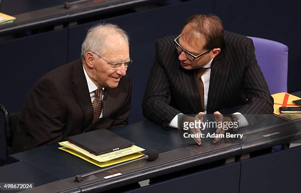 Finance Minister Wolfgang Schaeuble speaks to Transport and Digital Technologies Minister Alexander Dobrindt as they attend a meeting of the...