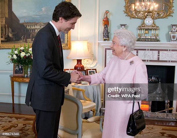 Prime Minister of Canada Justin Trudeau shake hands with Queen Elizabeth II during a private audience at Buckingham Palace on November 25, 2015 in...