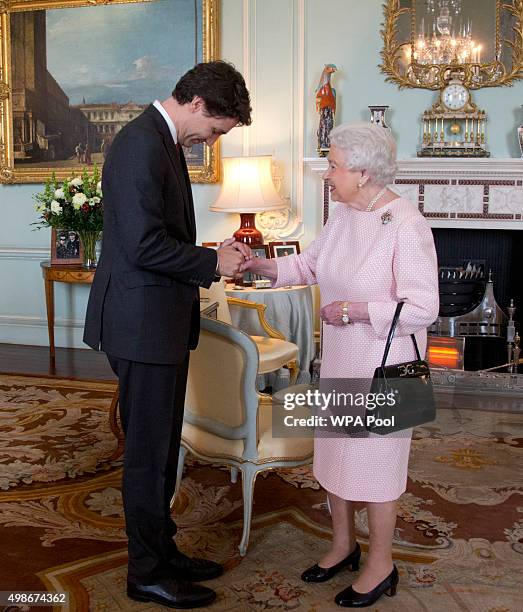 Prime Minister of Canada Justin Trudeau shake hands with Queen Elizabeth II during a private audience at Buckingham Palace on November 25, 2015 in...