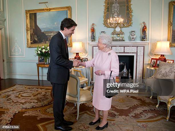 Prime Minister of Canada Justin Trudeau shake hands with Queen Elizabeth II during a private audience at Buckingham Palace on November 25, 2015 in...