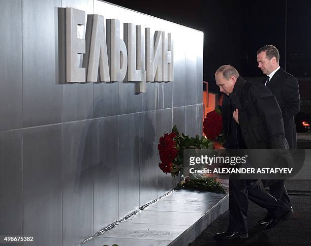 Russian President Vladimir Putin and Prime Minister Dmitry Medvedev lay flowers at a monument to first Russian president Boris Yeltsin in...