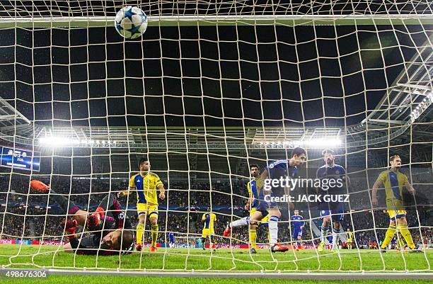 Macabbi Tel Aviv's goalkeeper Predrag Rajkovic fails to save a shot on goal by Chelsea's Brazilian midfielder Oscar during the UEFA Champions League,...