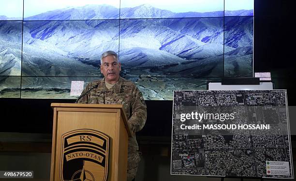 Commander of U.S. And NATO forces in Afghanistan, General John F. Campbell stands beside a map of the northern Afghan city of Kunduz as he addresses...