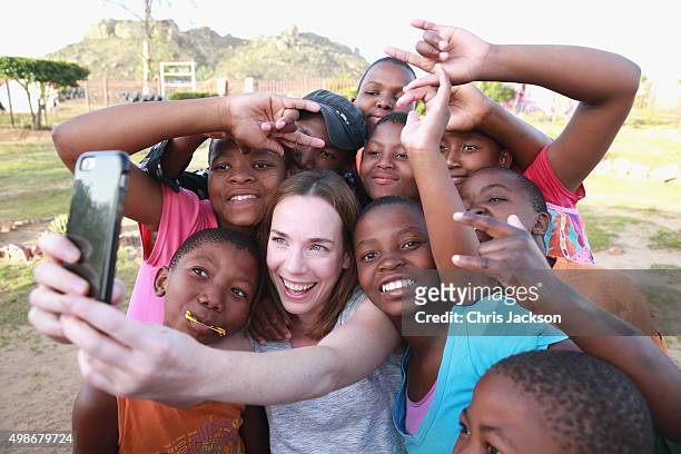 Actress Laura Main takes a 'selfie' with hearing impaired children at Kananelo School during a Sentebale programme visit on November 25, 2015 in...