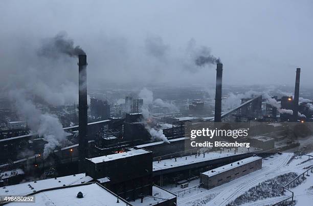 Vapor escapes from chimneys in the coke shop at the Evraz Consolidated West-Siberian Metallurgical Plant, operated by Evraz Plc, in Novokuznetsk,...
