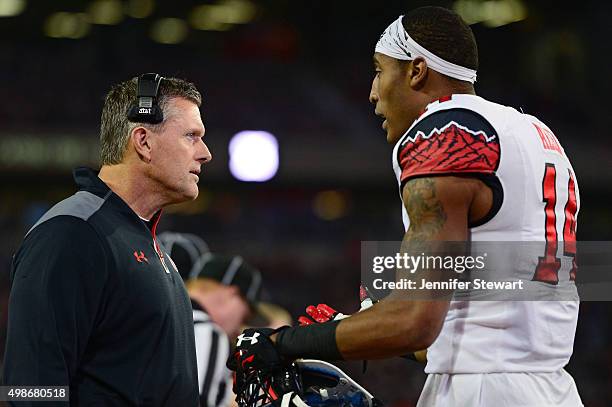 Defensive back Brian Allen of the Utah Utes talks with head coach Kyle Whittingham on the sidelines in the game against the Arizona Wildcats at...