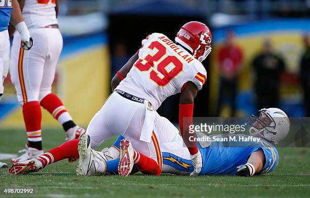 Husain Abdullah of the Kansas City Chiefs looks at Philip Rivers of the San Diego Chargers after tackling him during the second half of a game at...