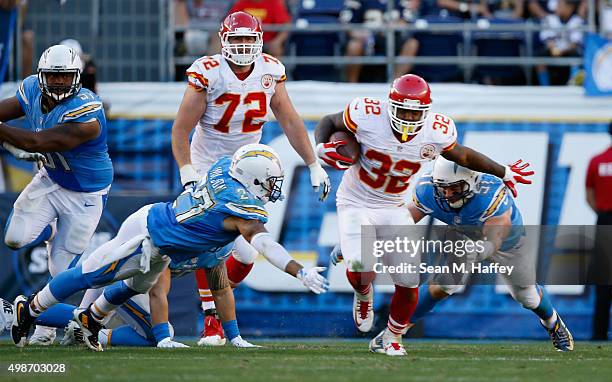 Spencer Ware of the Kansas City Chiefs eludes Jimmy Wilson of the San Diego Chargers and Kyle Emanuel of the San Diego Chargers during a game at...