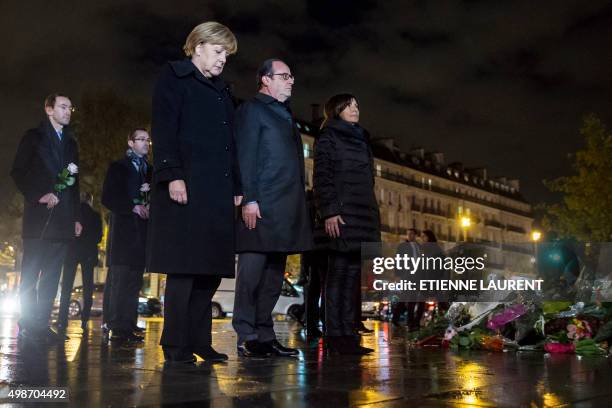 German Chancellor Angela Merkel, French President Francois Hollande and Paris Mayor Anne Hidalgo pay their respects to the victims of the November 13...