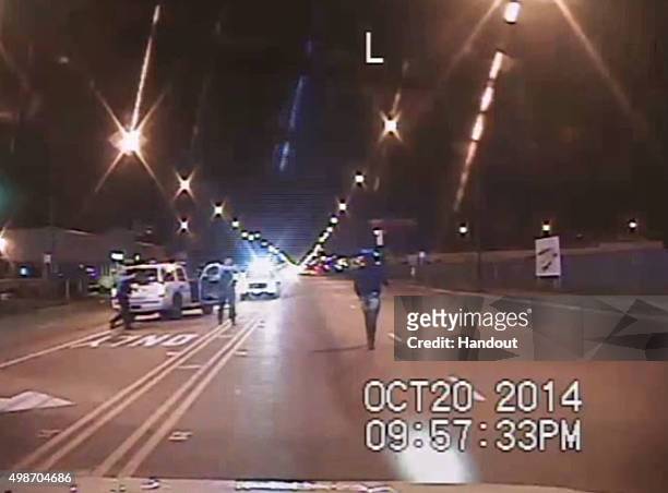 In this still image taken from a police vehicle dash camera released by the Chicago Police Department on November 24 Laquan McDonald walks up a...