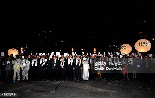 Prince Albert II of Monaco and delegates hold white peace cards after completing a Peace Walk from the Fairmont Hotel to the Grimaldi Forum ahead of...