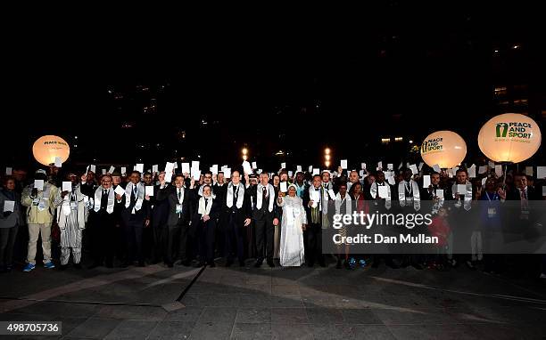 Prince Albert II of Monaco and delegates hold white peace cards after completing a Peace Walk from the Fairmont Hotel to the Grimaldi Forum ahead of...