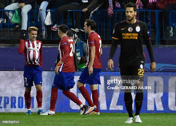 Atletico Madrid's French forward Antoine Griezmann celebrates a goal with teammates during the UEFA Champions League Group C football match Club...