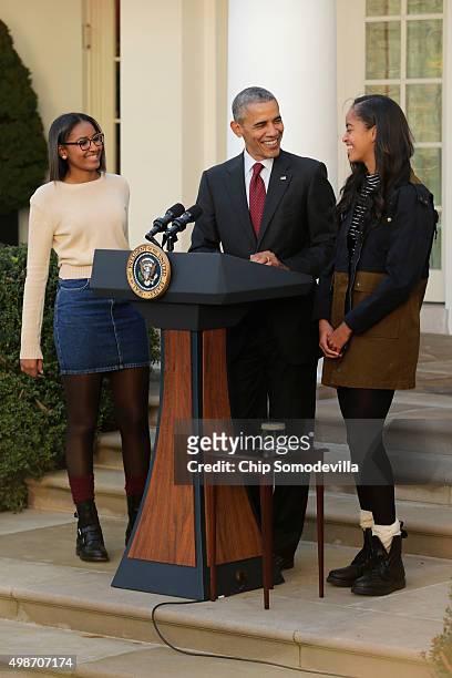 President Barack Obama delivers remarks with his daughters Sasha and Malia during the annual turkey pardoning ceremony in the Rose Garden at the...