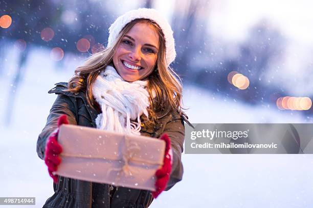 i have something for you - woman snow outside night stockfoto's en -beelden