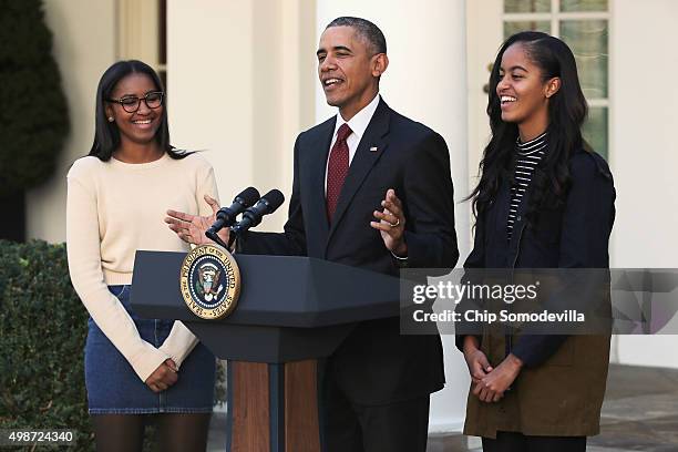 President Barack Obama delivers remarks with his daughters Sasha and Malia during the annual turkey pardoning ceremony in the Rose Garden at the...