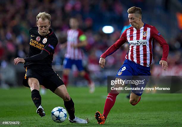 Semih Kaya of Galatasaray AS competes for the ball with Fernando Torres of Atletico de Madrid during the UEFA Champions League Group C match between...