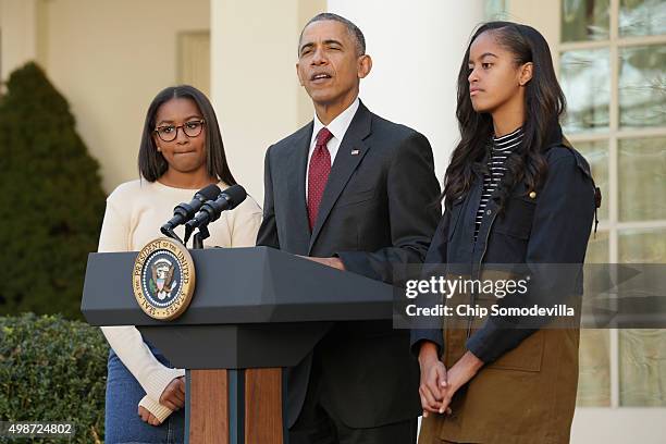 President Barack Obama delivers remarks with his daughters Sasha and Malia during the annual turkey pardoning ceremony in the Rose Garden at the...