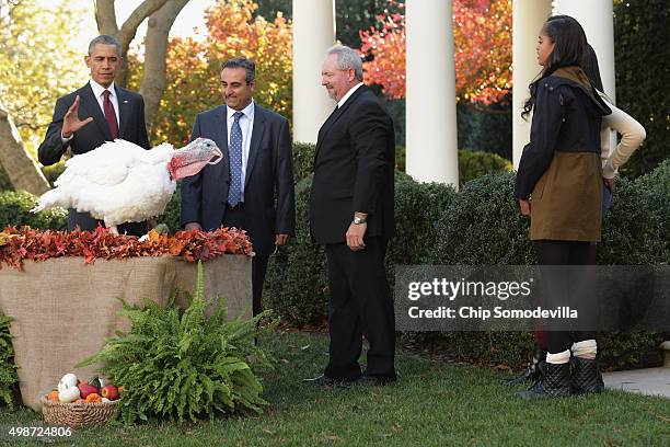 President Barack Obama "pardons" Abe, a 42-pound male turkey during a ceremony with National Turkey Federation Chairman Jihad Douglas , turkey farmer...