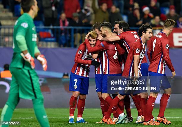 Atletico Madrid's players congratulate teammate French forward Antoine Griezmann after scoring a second goal during the UEFA Champions League Group C...