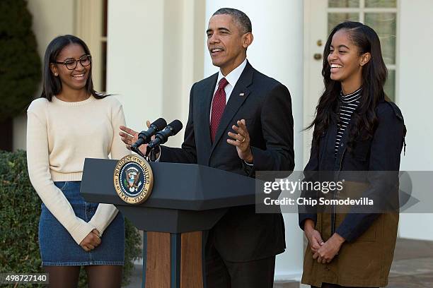 President Barack Obama delivers remarks with his daughters Sasha and Malia during the annual turkey pardoning ceremony in the Rose Garden at the...