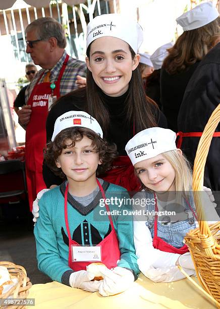 Actrors Emmy Rossum, August Maturo, and Mckenna Grace attend Thanksgiving for the Homeless at the Los Angeles Mission on November 25, 2015 in Los...