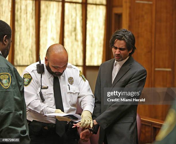 Miami Facebook killer, Derek Medina, is finger printed by corrections officer Juan DeJesus after he was found guilty of second-degree murder,...