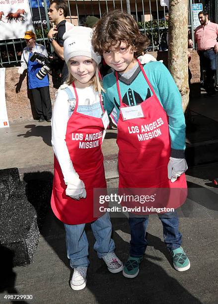 Actress McKenna Grace and actor August Maturo attend Thanksgiving for the Homeless at the Los Angeles Mission on November 25, 2015 in Los Angeles,...