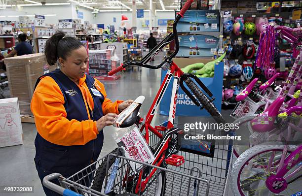 An employee tags an item for store pickup, a program where customers select and pay for items online for pickup, at a Wal-Mart Stores Inc. Location...