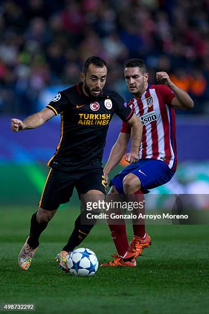 Olcan Adin of Galatasaray AS competes for the ball with Koke of Atletico de Madrid during the UEFA Champions League Group C match between Club...