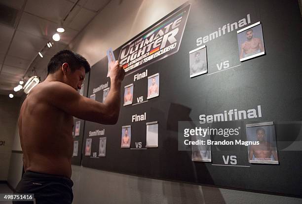 Enrique Barzola moves his name card to the finals after defeating Cesar Arsamendia in their semi-finals fight during the filming of The Ultimate...