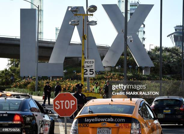 Heavily-armed police keep watch at Los Angeles International Airport as security is increased for the Thanksgiving holiday and after threats from...