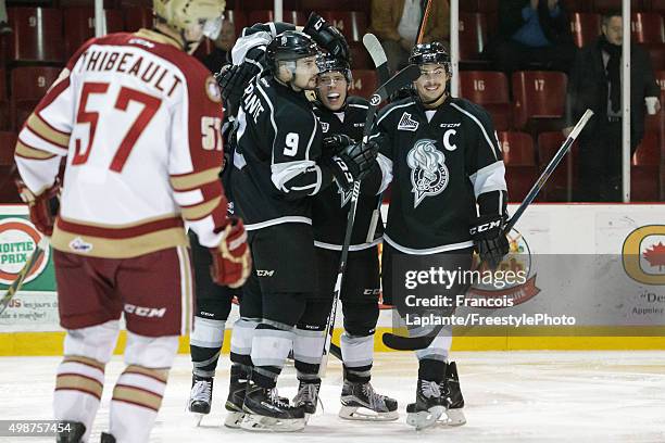 Vitalii Abramov of the Gatineau Olympiques celebrates his second period goal with teammates Yan Pavel Laplante and Alexandre Carrier as Francis...