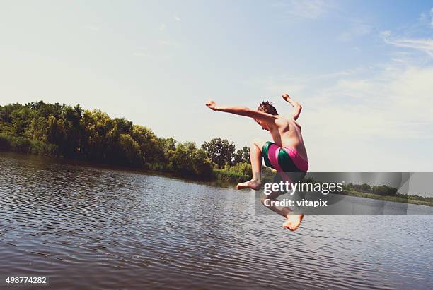 boy jumping into the river - jumping into lake stock pictures, royalty-free photos & images