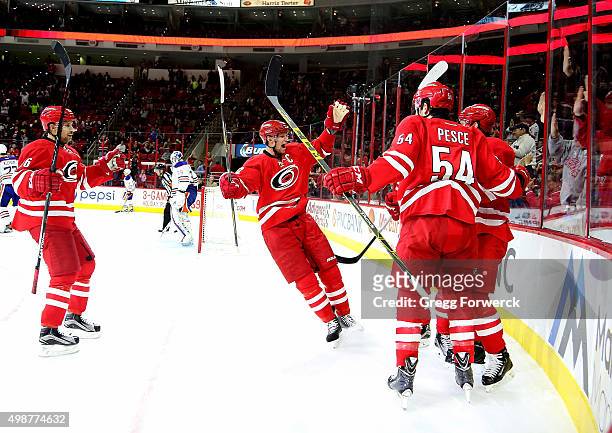 Elias Lindholm of the Carolina Hurricanes celebrates his second period goal with teammates Eric Staal, Brett Pesce, and John-Michael Liles during a...