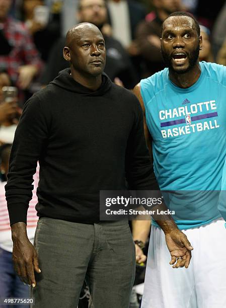 Owner of the Charlotte Hornets, Michael Jordan, talks to player Al Jefferson during their game against the Washington Wizards at Time Warner Cable...