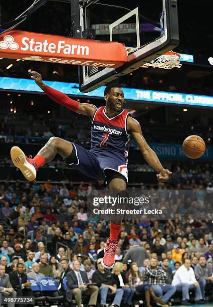 John Wall of the Washington Wizards reacts after dunking the ball during their game against the Charlotte Hornets at Time Warner Cable Arena on...