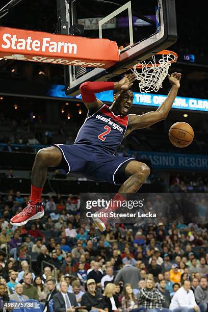 John Wall of the Washington Wizards reacts after dunking the ball during their game against the Charlotte Hornets at Time Warner Cable Arena on...