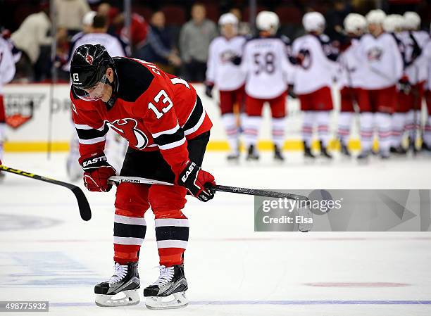 Mike Cammalleri of the New Jersey Devils reacts to the loss as the Columbus Blue Jackets celebrate after the game on November 25, 2015 at the...