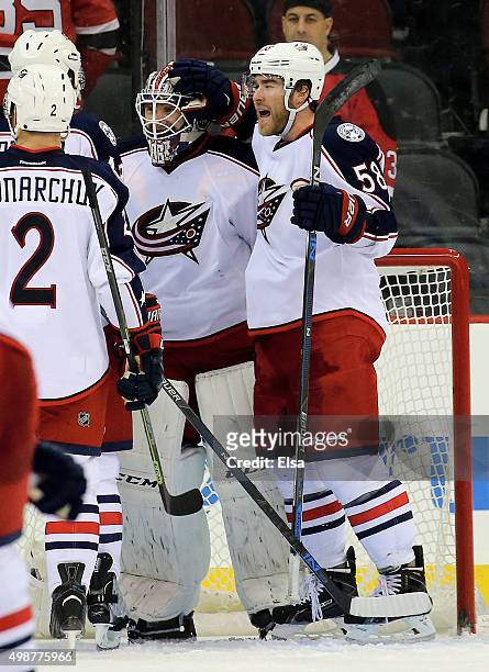 David Savard of the Columbus Blue Jackets celebrates the win with teammate Sergei Bobrovsky after the game against the New Jersey Devils on November...